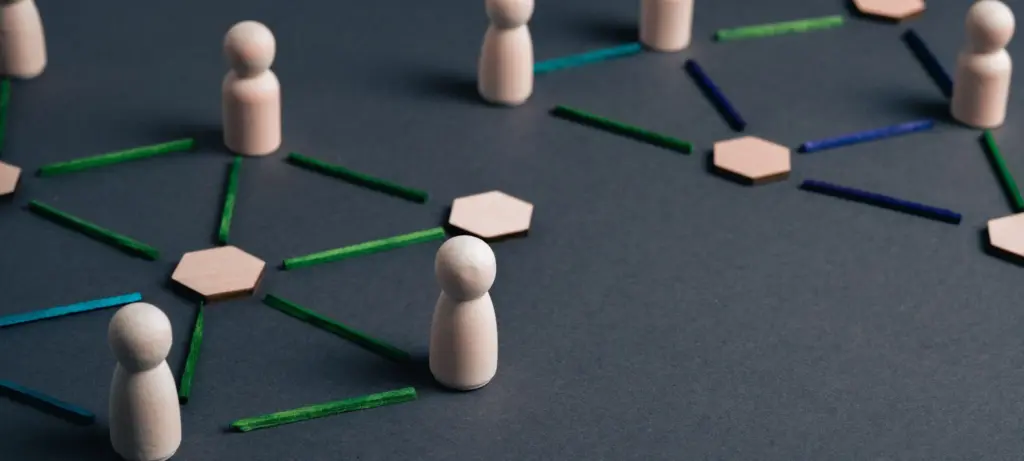 Wooden figures connected across a decentralized blockchain network