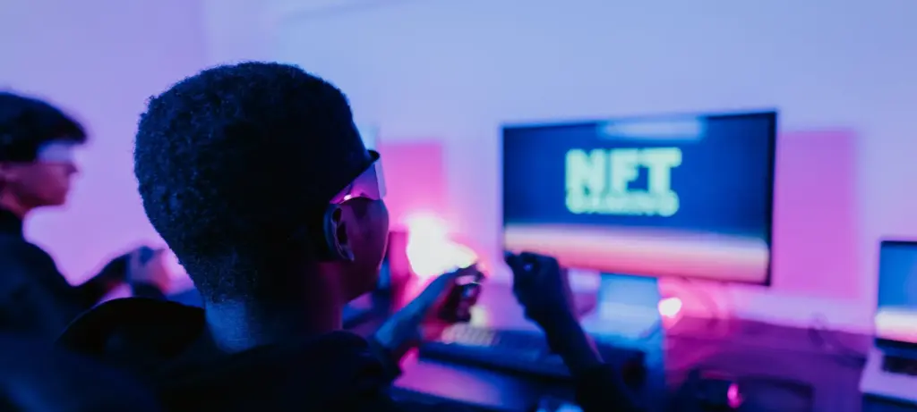 Person playing an NFT dApp game on a computer
