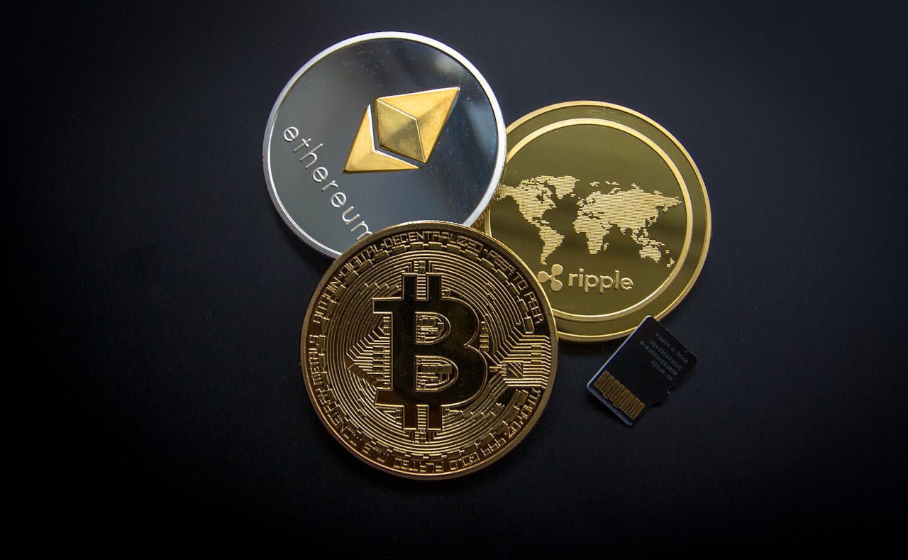 Bitcoin Ethereum and Ripple Coins against black background