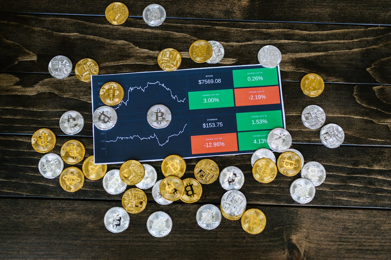 Bitcoin chart and coins on wooden background