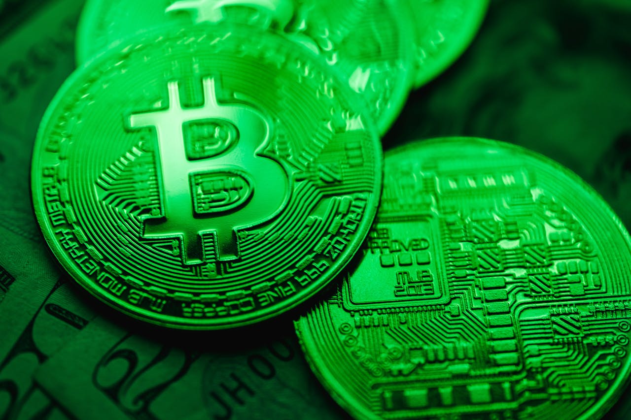 Green Bitcoins on US dollar notes