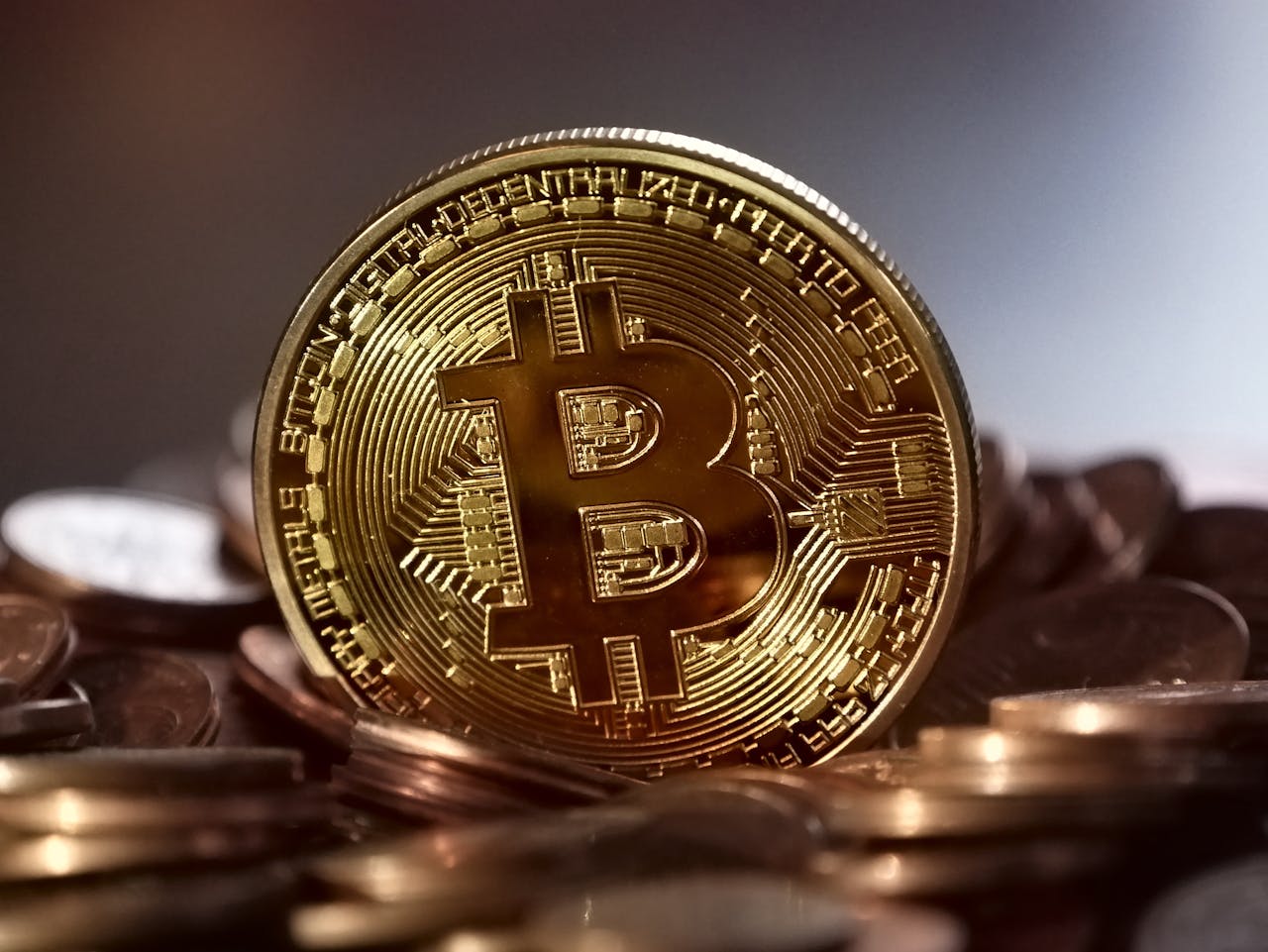Bitcoin on top of pile of coins