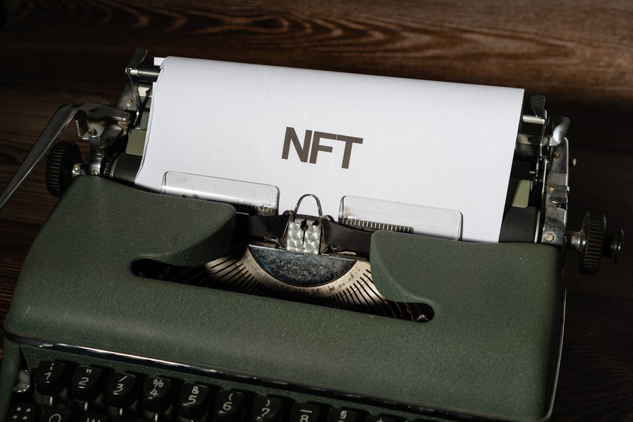 typewriter with white paper and the word NFT written on it