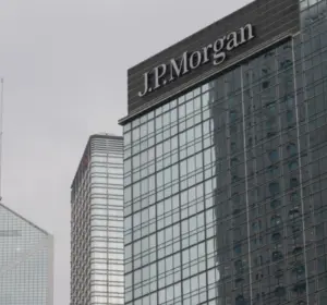 J.P. Morgan company name displayed on the exterior of a modern glass office building.