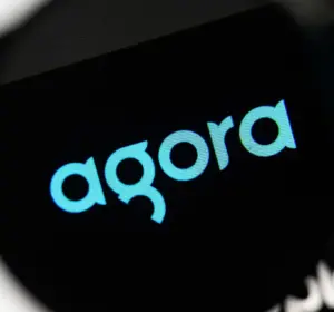 Agora logo displayed on a digital screen against a dark background in a close-up technology image.