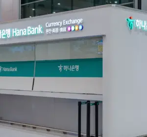 Hana Bank currency exchange counter inside a modern terminal with Korean and English signage.