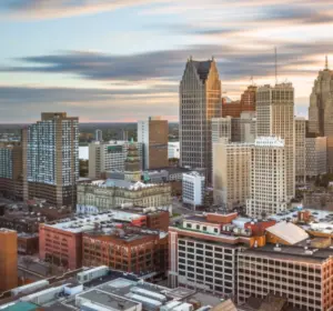 Aerial view of downtown Detroit skyline in Michigan with high-rise buildings under a sunset sky