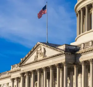 U.S. Senate building in Washington, D.C., with an American flag flying against a blue sky